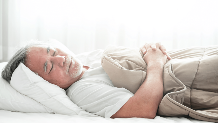 Image of elderly man sleeping in bed