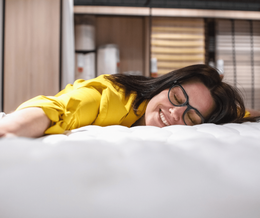 Woman laying on bed smiling